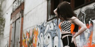 In Charlotte we wanted to fuck Carrie woman in black and white polka dot dress standing near graffiti wall during daytime