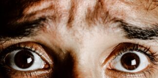 Anxiety Milkshake Crop face of person with brown eyes with fear on face looking at camera