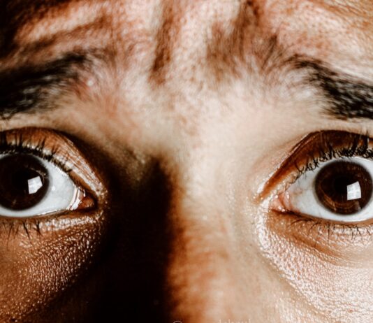 Anxiety Milkshake Crop face of person with brown eyes with fear on face looking at camera