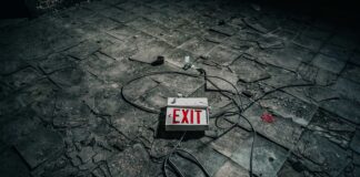 If you look back far enough grey exit sign board on grey pavement