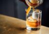 Poetry liquor pouring on clear shot glass