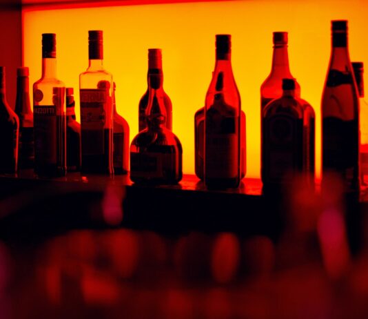 As the sun sets assorted bottle on table