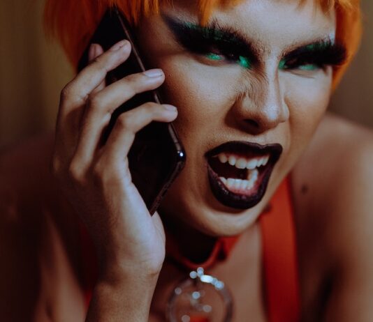 Bitchy little bitch Angry young androgynous person shouting while talking on smartphone